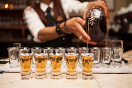 pour of liquor - Close-up of man, bartender pouring alcohol into shot glasses, Toronto, Ontario, Canada Photographie de stock - Rights-Managed, Code: 700-07453800