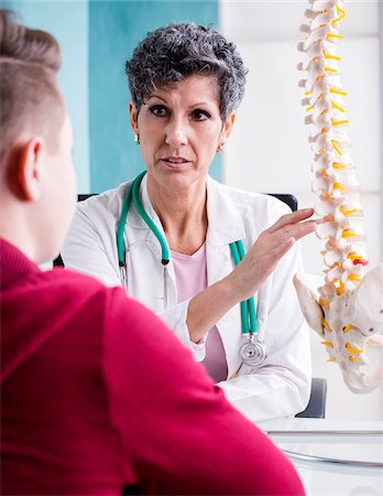 Doctor talking with Teenage Patient in Doctor's Office Stock Photo - Rights-Managed, Code: 700-07487574