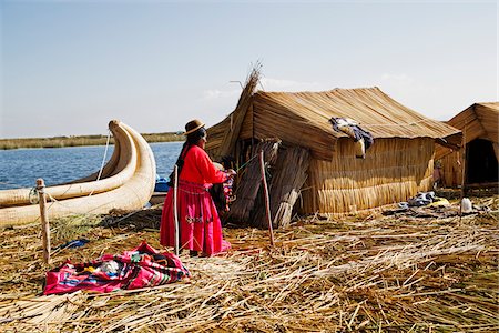 red home people - Woman in Peruvian clothing standing next to straw house, Floating Island of Uros, Lake Titicaca, Peru Stock Photo - Rights-Managed, Code: 700-07529097