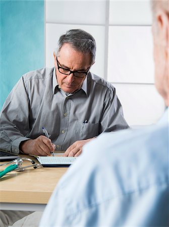 simsearch:700-07529235,k - Senior, male doctor conferring with male patient in office, Germany Stock Photo - Rights-Managed, Code: 700-07529239