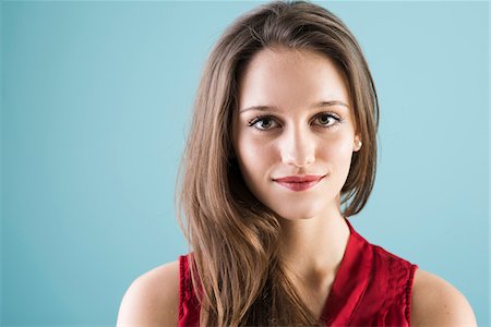 pretty smiling portrait - Close-up portrait of teenage girl looking at camera, studio shot on blue background Stock Photo - Rights-Managed, Code: 700-07567432