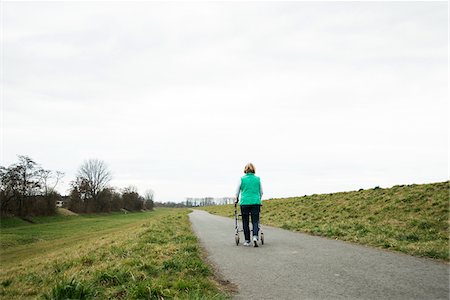 pflasterstrasse - Backview of senior woman walking along path using walker in nature, Germany Stockbilder - Lizenzpflichtiges, Bildnummer: 700-07584818