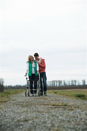 simsearch:600-06782244,k - Teenage grandson with grandmother using walker on pathway in park, walking in nature, Germany Photographie de stock - Rights-Managed, Code: 700-07584825