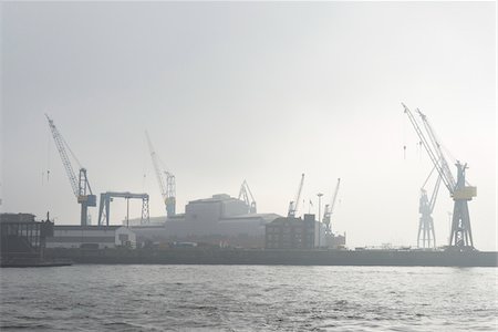 View of Harbour with container cranes at loading docks in morning mist, Hamburg, Germany Stock Photo - Rights-Managed, Code: 700-07599793