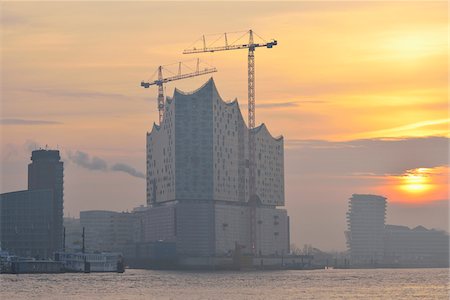 Elbe Philharmonic Hall with Construction Cranes on Elbe River at Sunrise, HafenCity, Hamburg, Germany Stock Photo - Rights-Managed, Code: 700-07591292