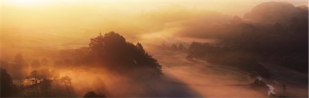 Back lit misty wooded valley at sunrise in summer, Snowdonia National Park, North Wales Stock Photo - Rights-Managed, Code: 700-07672283