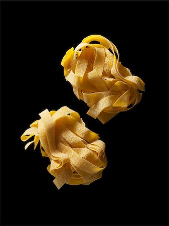 pasta overhead - Pappardelle egg noodle nest on black background, Studio Shot Stock Photo - Rights-Managed, Code: 700-07672309