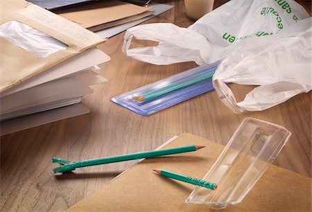 Close-up of envelopes, file folders, chewed pencils and plastic bag on office desk Stock Photo - Rights-Managed, Code: 700-07698671