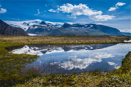 Scenic view of mountains reflected in glacial lake, Svinafellsjokull, Skaftafell National Park, Iceland Stock Photo - Rights-Managed, Code: 700-07760112