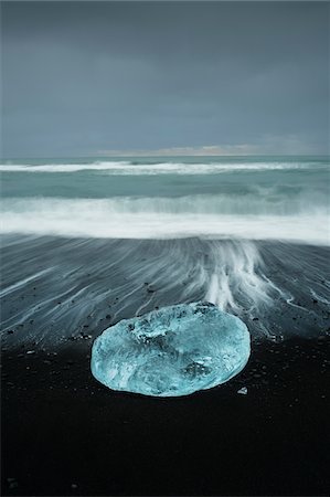 Long Exposure of Iceberg Washed up on Black Volcanic Beach at Dusk, Iceland Stock Photo - Rights-Managed, Code: 700-07840743