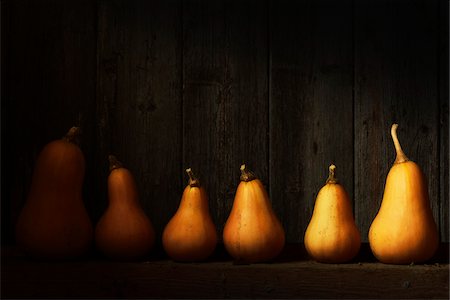 dark background vegetable - Butternut Squash Ripening on Shelf in Barn in Autumn Stock Photo - Rights-Managed, Code: 700-07965819