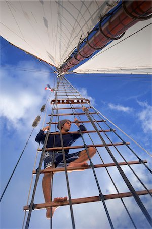 sail (fabric for transmitting wind) - Man Searches for Signs of Sea Life or other Boats while aloft in Ship's Rigging Stock Photo - Rights-Managed, Code: 700-07965862