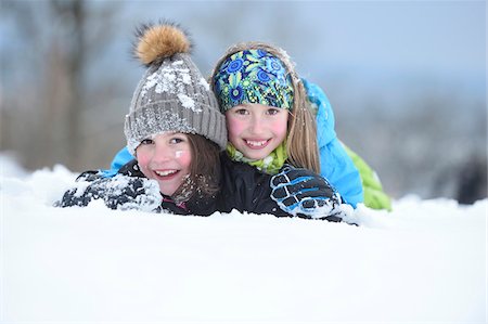 sólo niños - Close-up portrait of two girls playing in the snow, winter, Bavaria, Germany Foto de stock - Con derechos protegidos, Código: 700-07991768