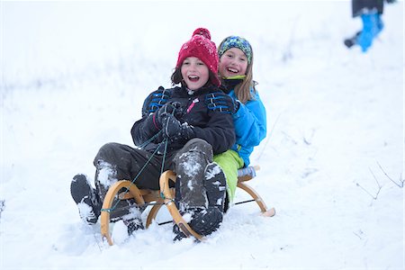 sólo niños - Two girls playing in the snow with sled, winter, Bavaria, Germany Foto de stock - Con derechos protegidos, Código: 700-07991776