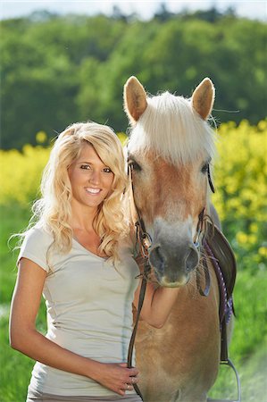 Portrait of a young woman standing beside a haflinger horse in spring, Bavaria, Germany Stock Photo - Rights-Managed, Code: 700-08080587