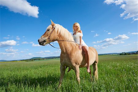 Portrait of a young woman sitting on a Haflinger horse in a meadow in spring, Bavaria, Germany Photographie de stock - Rights-Managed, Code: 700-08080582
