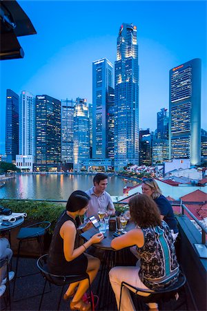 singapore food - People at Bar at Boat Quay overlooking Skyline at Dusk, Singapore Stock Photo - Rights-Managed, Code: 700-08167182