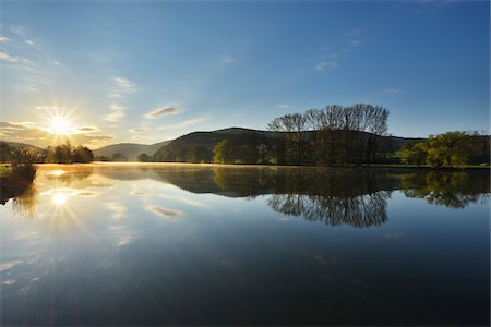 Landscape with Sun Reflected in the River Main in the Morning, Spring, Collenberg, Churfranken, Spessart, Miltenberg-District, Bavaria, Germany Stock Photo - Rights-Managed, Code: 700-08231174
