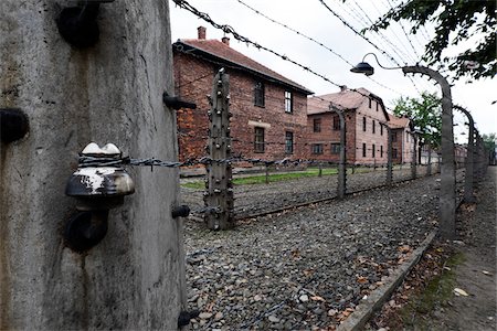 Barbed wire fence and buildings, Auschwitz, Poland Photographie de stock - Rights-Managed, Code: 700-08232194