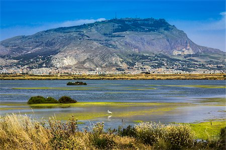 province of trapani - Tranquil view of the salt marshes at the Trapani Salt Pans and Nature Reserve with the city of Trapani in the background in Sicily, Italy Photographie de stock - Rights-Managed, Code: 700-08701956