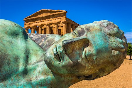 sculpture and close up - Fallen Icarus Sculpture by Igor Mitoraj in front of Temple of Concordia at Valle dei Templi in Ancient Greek City at Agrigento, Sicily, Italy Stock Photo - Rights-Managed, Code: 700-08702034