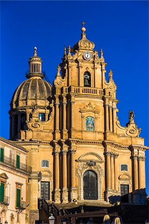 simsearch:841-05847888,k - Rooftop and upper section of the Cathedral of Saint George (Duomo di San Giorgio) against a blue sky in Ragusa in Sicily, Italy Foto de stock - Con derechos protegidos, Código: 700-08723100