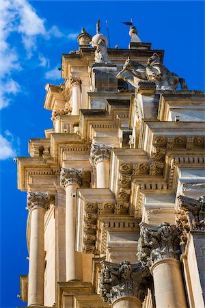 Low angle view of the ornate mouldings and pillars of the Cathedral of Saint George (Duomo di San Giorgio) against a blue sky in Ragusa in Sicily, Italy Stock Photo - Rights-Managed, Code: 700-08723102
