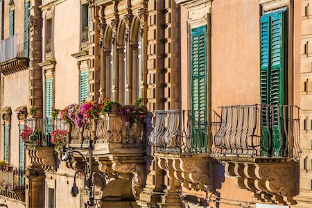 Close-up of decorated balconies and shuttered windows on building in Ragusa in Sicily, Italy Photographie de stock - Rights-Managed, Code: 700-08723114