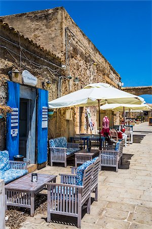 Outdoor cafe and shops along cobblestone street in the village of Marzamemi in the Province of Syracuse in Sicily, Italy Stock Photo - Rights-Managed, Code: 700-08723147