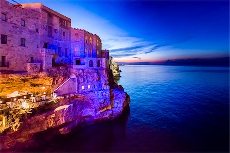 dusk photos of restaurants - Cliff Restaurant Grotta Palazzese at Dusk in Polignano a Mare, Puglia, Italy Stock Photo - Rights-Managed, Code: 700-08739693