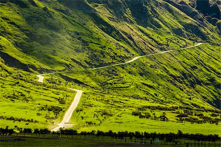 Green fields on mountainside with widning road to the Treble Cone ski area at Glendhu Bay in the Otago Region of New Zealand Photographie de stock - Rights-Managed, Code: 700-08765542