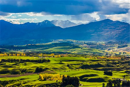 simsearch:600-08578863,k - Rain clouds over the mountains and the Wakatipu Basin near Queenstown in the Otago Region of New Zealand Stock Photo - Rights-Managed, Code: 700-08765554