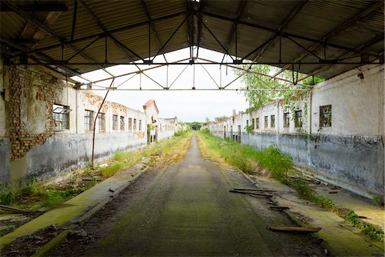 Roof framework over road and old decayed buildings in Mecklenburg Vorpommern, Germany Stock Photo - Premium Rights-Managed, Artist: Michael Breuer, Image code: 700-08926759