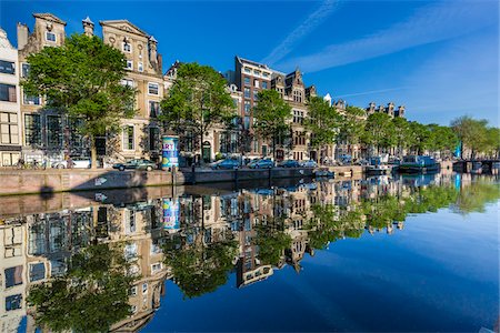 Typical houses refelected on the Herengracht Canal in Grachtengordel in the city center of Amsterdam, Holland Stock Photo - Rights-Managed, Code: 700-08973499