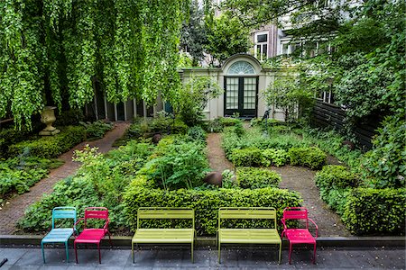 simsearch:700-09013834,k - Shady garden with chairs at the Huis Marseille, Museum for Photography along the Keizersgracht in the city center of Amsterdam, Holland Stock Photo - Rights-Managed, Code: 700-08973511