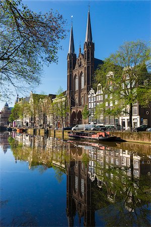 Tranquil view of the De Krijtberg Church along the Singel Canal in Grachtengordel in Amsterdam, Holland Stock Photo - Rights-Managed, Code: 700-08973535