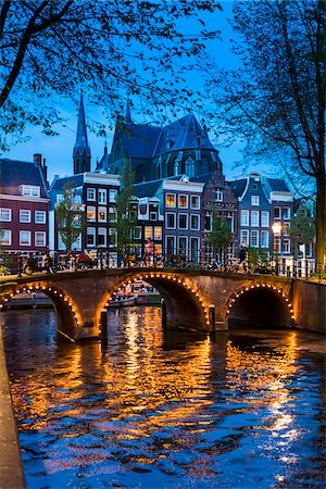 simsearch:700-01742897,k - Stone bridge crossing the Leidsegracht at dusk with lights reflected in the canal in Amsterdam, Holland Foto de stock - Con derechos protegidos, Código: 700-08973539