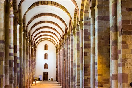 simsearch:700-05642433,k - View looking down one of the aisles of the interior of the Speyer Cathedral with its stone columns and vaulted ceilings, Speyer, Germany Stock Photo - Rights-Managed, Code: 700-08973579