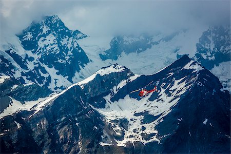 Helicopter flying through the mountain mist over the Pennine Alps near Zermatt in Switzerland Foto de stock - Con derechos protegidos, Código: 700-08986335