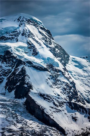 Snow covered mountain top of the Pennine Alps at Zermatt in Switzerland Fotografie stock - Rights-Managed, Codice: 700-08986337