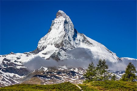 The Matterhorn with grey mountain clouds on a sunny day at Zermatt, Switzerland Stock Photo - Rights-Managed, Code: 700-08986351