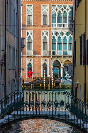 Small bridge crossing a canal looking through to sunlit buildings along along the Grand Canal in Venice, Italy Stock Photo - Rights-Managed, Code: 700-08986651