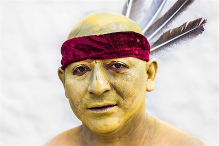 simsearch:700-09088067,k - Close-up portrait of a male, indigenous tribal dancer with painted skin and feathered headband at the St Michael Archangel Festival parade in San Miguel de Allende, Mexico Stock Photo - Rights-Managed, Code: 700-09088056