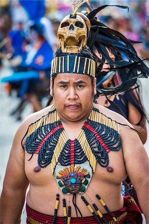 Portrait of male, indigenous tribal dancer looking at the camera wearing beaded collar and skull headdress in the St Michael Archangel Festival parade in San Miguel de Allende, Mexico Stock Photo - Rights-Managed, Code: 700-09088087
