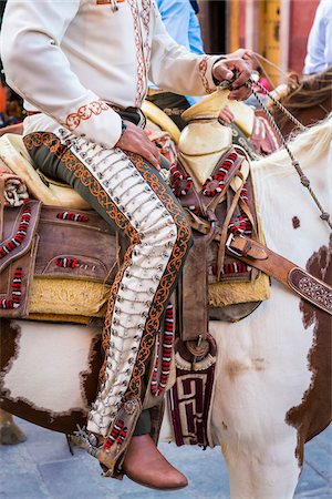parade carnavalesque - Close-up of Mexican man's legs wearing chaps while on horseback riding in the procession of Our Lady of Loreto in San Miguel de Allende, Mexico Photographie de stock - Rights-Managed, Code: 700-09088153