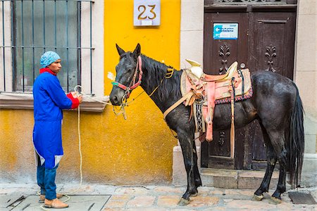 Man in traditional clothing tying up horse during historic horseback parade celebrating Mexican Independence Day in San Miguel de Allende, Mexico Stock Photo - Rights-Managed, Code: 700-09088183