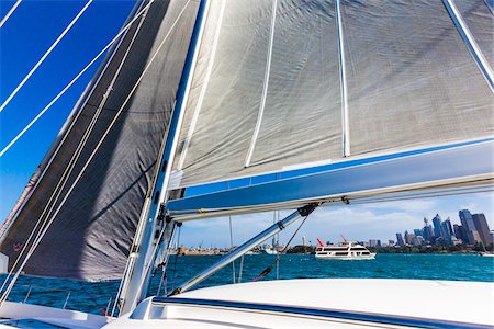 Close-up of sails on sailboat with yacht in the background, sailing in the Sydney Harbour in Sydney, New South Wales, Australia Photographie de stock - Rights-Managed, Code: 700-09101103