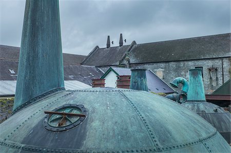 Old, copper pot stills on rooftop of the historical Kilbeggan Distillery of Irish whiskey in County Westmeath, Ireland Stock Photo - Rights-Managed, Code: 700-09111065