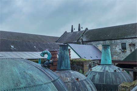 simsearch:700-08146286,k - Old, copper pot stills on rooftop of the historical Kilbeggan Distillery of Irish whiskey in County Westmeath, Ireland Stock Photo - Rights-Managed, Code: 700-09111067