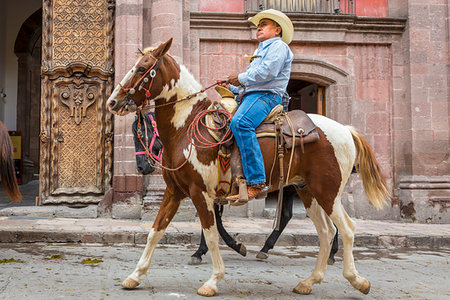 simsearch:862-03352287,k - Cowboy on horseback riding in parade to the Parroquia de San Miguel Arcangel in St Michael Archangel Festival, San Miguel de Allende, Mexico Stock Photo - Rights-Managed, Code: 700-09226995